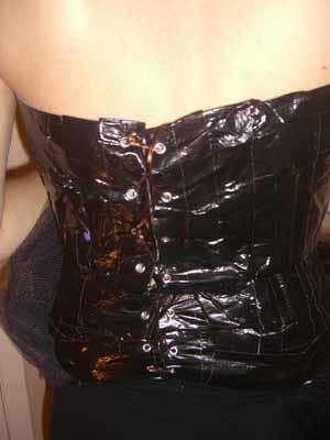 After cutting the back open and binding the cut with more duck tape grommets were used to lace the bodice closed.